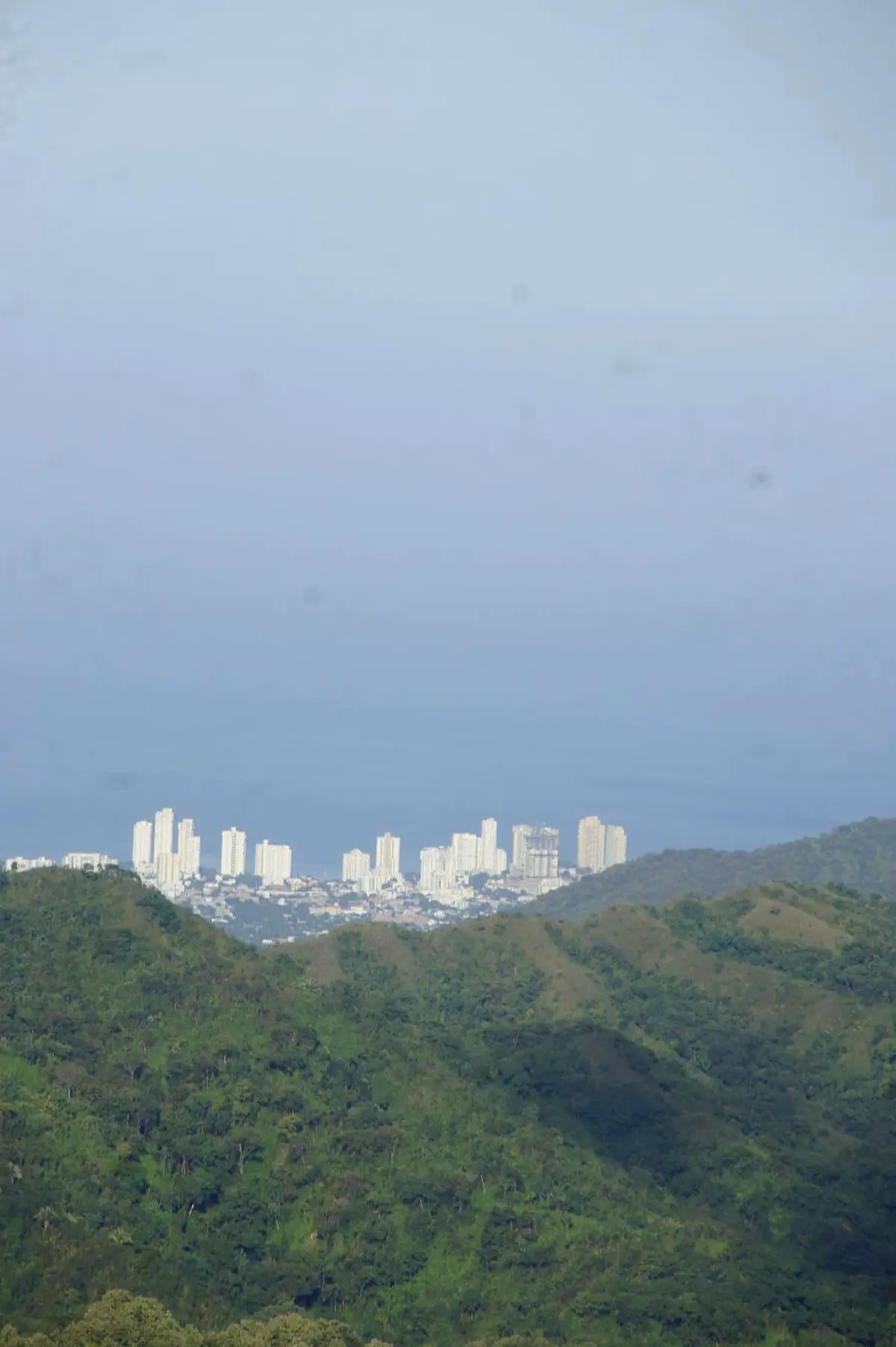 Santa Marta’s high-rises above green hills under a pale sky, from the deluxe double